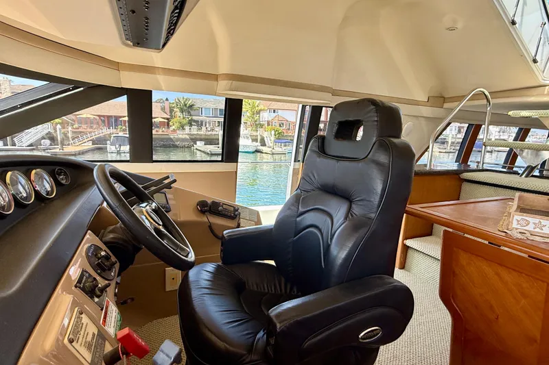 Slide: The Image of Interior of 2000 Carver 53 Voyager yacht with captain's chair and helm. - 70