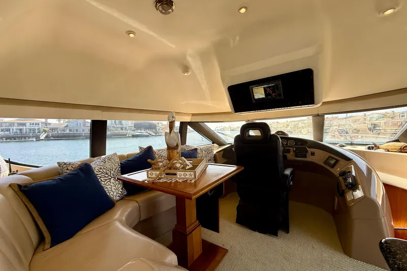 Slide: The Image of Luxurious interior of a 2000 Carver 53 Voyager yacht with plush seating and navigation controls. - 72