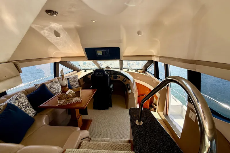 Slide: The Image of Luxurious interior of 2000 Carver 53 Voyager yacht with helm and seating area. - 77