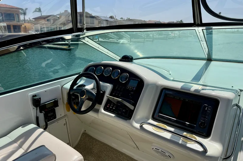 Slide: The Image of Interior helm of 2000 Carver 53 Voyager yacht with steering wheel and navigation instruments. - 79