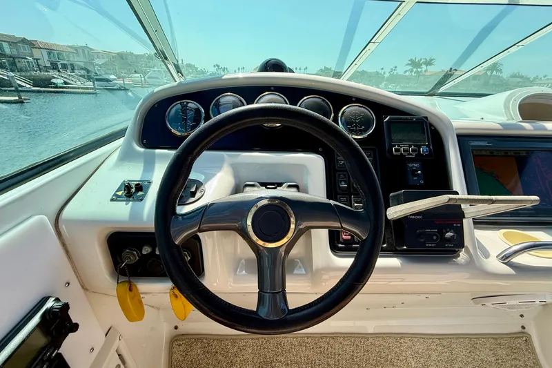 Slide: The Image of Steering wheel and dashboard of a 2000 Carver 53 Voyager yacht. - 81