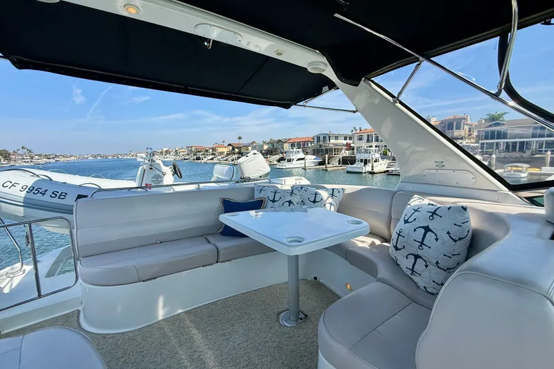Slide: The Image of Luxurious seating area on a 2000 Carver 53 Voyager yacht with waterfront view. - 84
