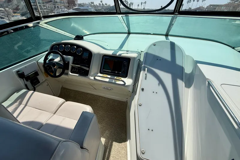 Slide: The Image of Interior helm of 2000 Carver 53 Voyager yacht with steering wheel and navigation equipment. - 85