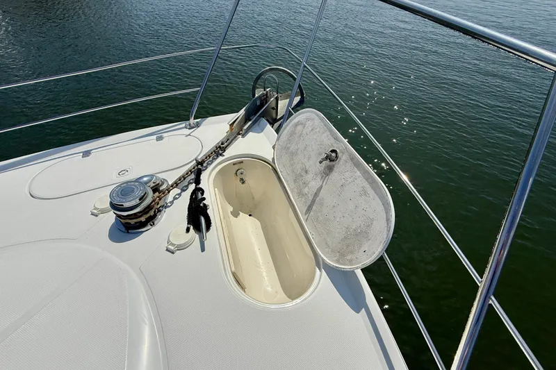 Slide: The Image of Bow deck of 2000 Carver 53 Voyager yacht with anchor locker open. - 87