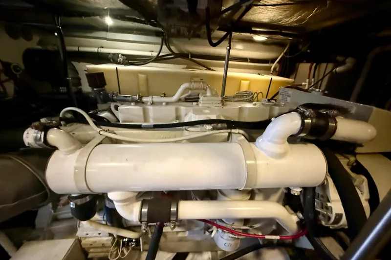 Slide: The Image of Engine room of a 2000 Carver 53 Voyager yacht, showcasing mechanical components. - 99
