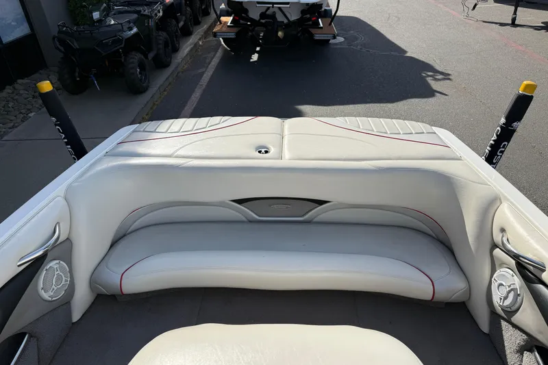 Slide: The Image of 2009 Malibu Response LXi boat interior with white seating and speaker system. - 13