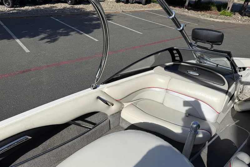 Slide: The Image of 2009 Malibu Response LXi boat interior with white seating and sleek design. - 15