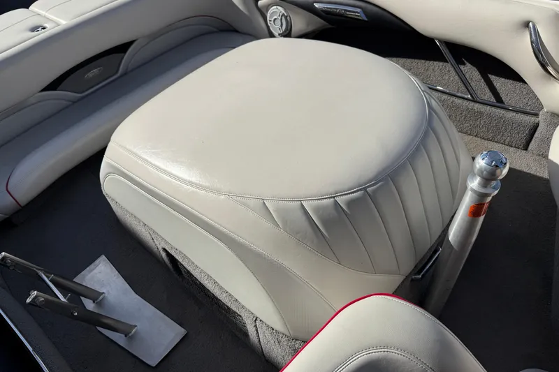 Slide: The Image of 2009 Malibu Response LXi boat interior with beige seating and metal fixtures. - 16