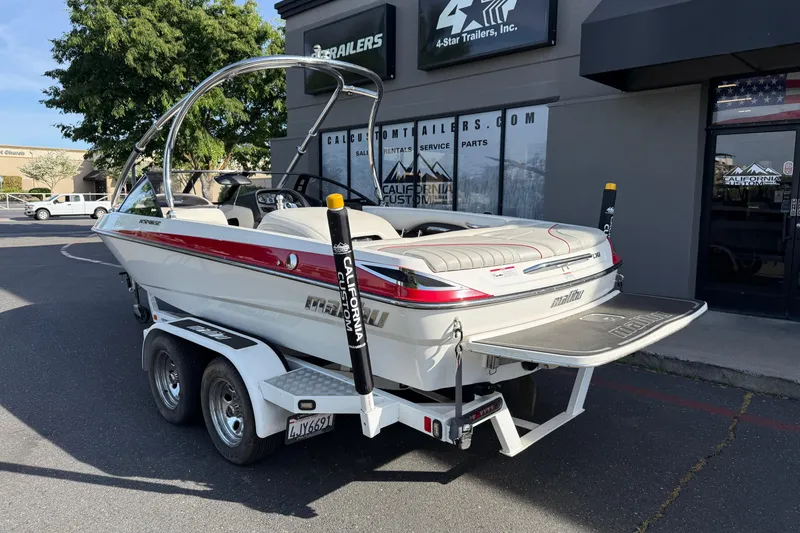 Slide: The Image of 2009 Malibu Response LXi boat on trailer outside dealership. - 2