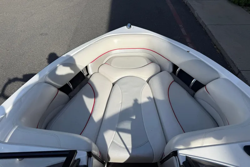 Slide: The Image of 2009 Malibu Response LXi boat interior with white and red-trimmed seating. - 20