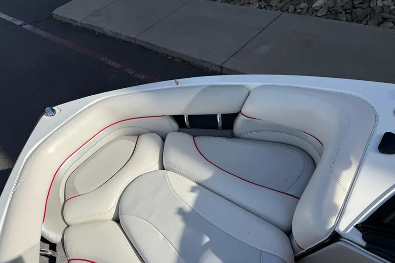 Slide: The Image of 2009 Malibu Response LXi boat interior with white and red-trimmed seating. - 22