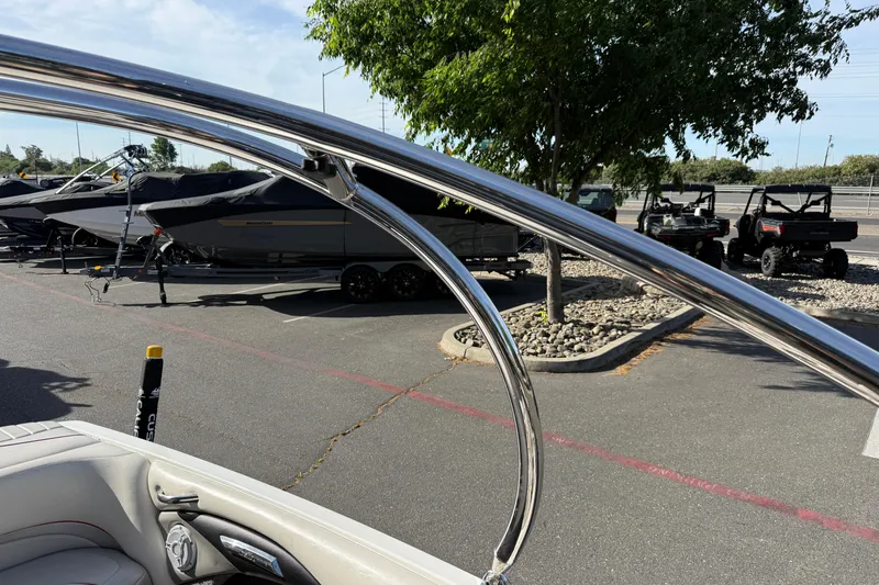 Slide: The Image of 2009 Malibu Response LXi boat with chrome details in a parking lot. - 23