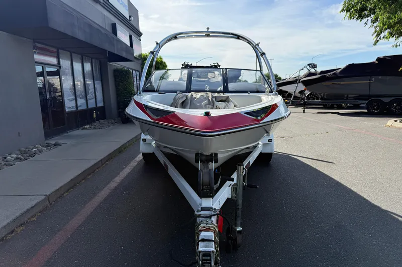 Slide: The Image of 2009 Malibu Response LXi boat on trailer, parked outside dealership. - 6