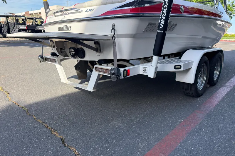 Slide: The Image of 2009 Malibu Response LXi boat on trailer, rear view, parked on asphalt. - 9