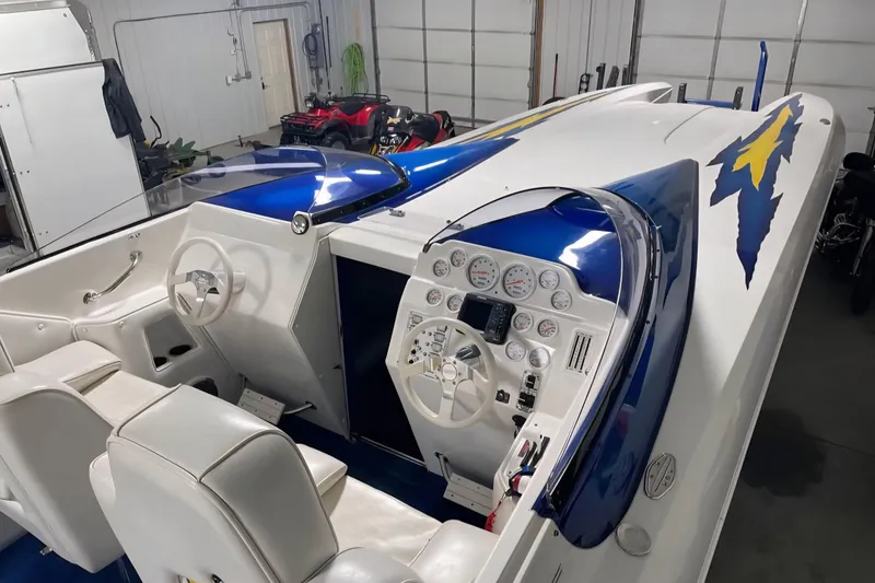 Slide: The Image of 2001 Eliminator 36 Daytona boat interior with white seating and detailed dashboard. - 3
