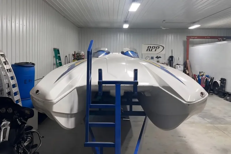 Slide: The Image of 2001 Eliminator 36 Daytona speedboat in a garage, viewed from the front. - 6