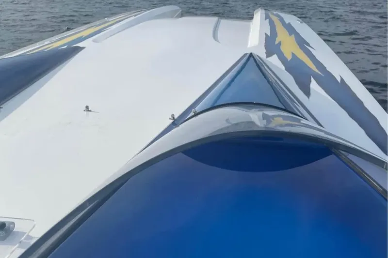 Slide: The Image of 2001 Eliminator 36 Daytona boat with sleek design on water. - 7