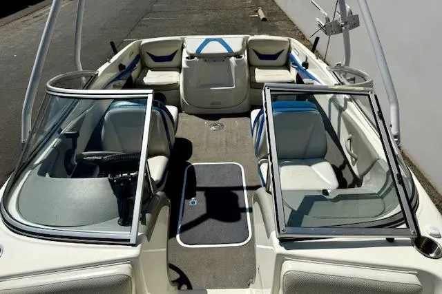 Slide: The Image of 2006 Bayliner 205 boat interior with open windshield and seating arrangement. - 10
