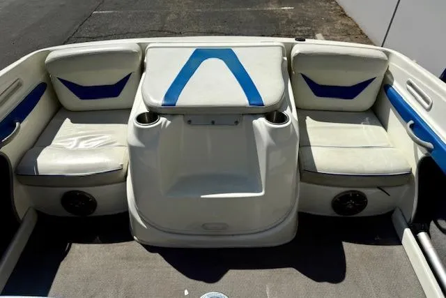Slide: The Image of Interior seating of a 2006 Bayliner 205 boat with white and blue upholstery. - 13