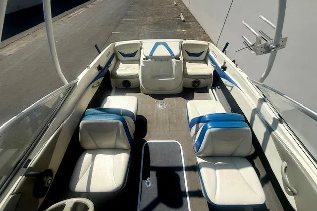 Slide: The Image of Interior view of a 2006 Bayliner 205 boat with white and blue seating. - 16