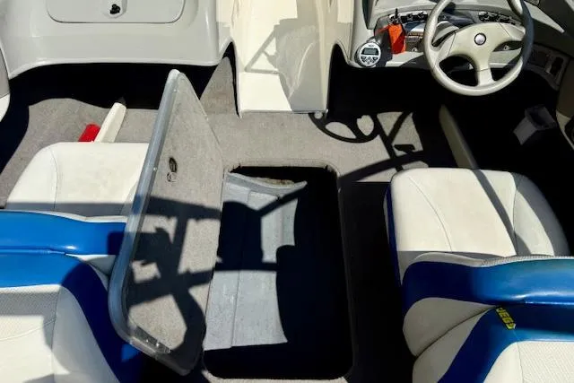 Slide: The Image of Interior of a 2006 Bayliner 205 boat with open storage compartment and seating. - 17