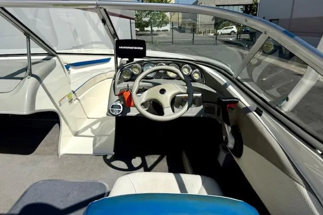 Slide: The Image of 2006 Bayliner 205 boat interior with steering wheel and dashboard controls. - 18