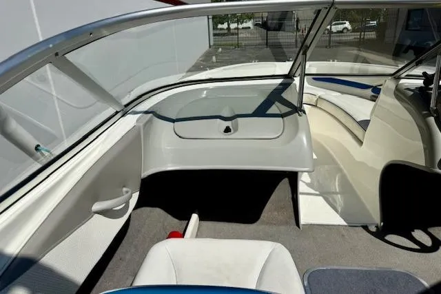 Slide: The Image of 2006 Bayliner 205 boat interior with seating and windshield, showcasing sleek design and comfort. - 7