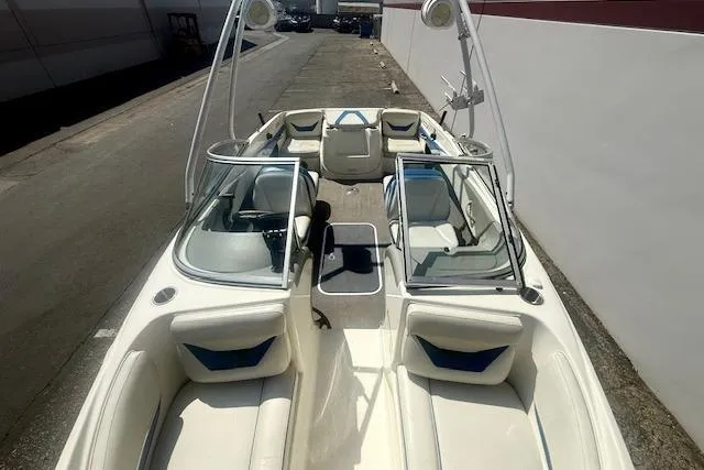 Slide: The Image of 2006 Bayliner 205 boat interior with white seating and open deck layout. - 9