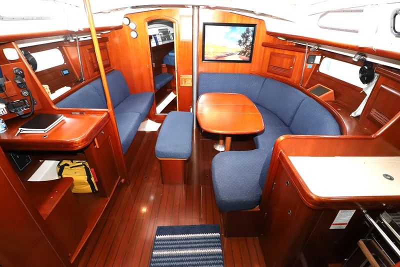 Slide: The Image of Interior of 2005 Beneteau Oceanis Clipper 423 yacht with wooden finish and blue seating. - 1