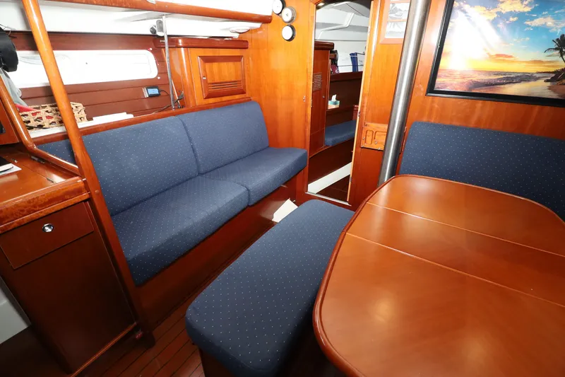 Slide: The Image of Interior of 2005 Beneteau Oceanis Clipper 423 yacht with wooden furnishings and blue seating. - 12
