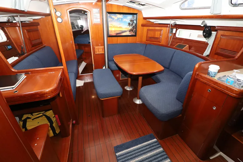 Slide: The Image of Interior of 2005 Beneteau Oceanis Clipper 423 yacht with wooden furnishings and blue seating. - 3