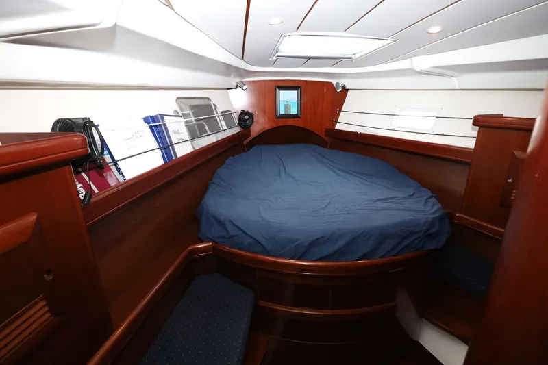 Slide: The Image of Interior cabin of 2005 Beneteau Oceanis Clipper 423 with cozy bed and wooden finish. - 7