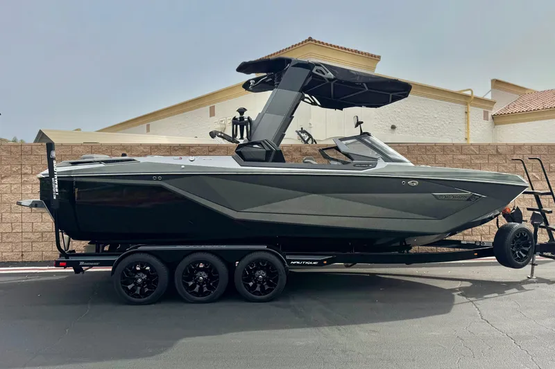 The Image of 2022 Nautique Super Air Nautique G25 Paragon boat on trailer, side view. - 0