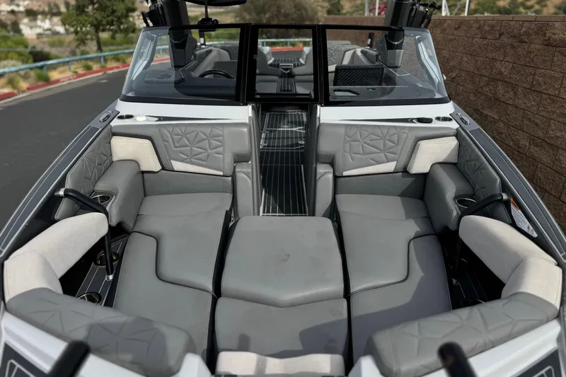 Slide: The Image of 2022 Nautique Super Air Nautique G25 Paragon interior with luxurious gray seating. - 13
