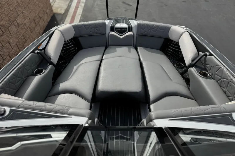 Slide: The Image of 2022 Nautique Super Air Nautique G25 Paragon interior with luxurious gray seating and cup holders. - 14