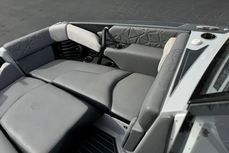 Slide: The Image of 2022 Nautique Super Air Nautique G25 Paragon interior with luxurious gray seating. - 16