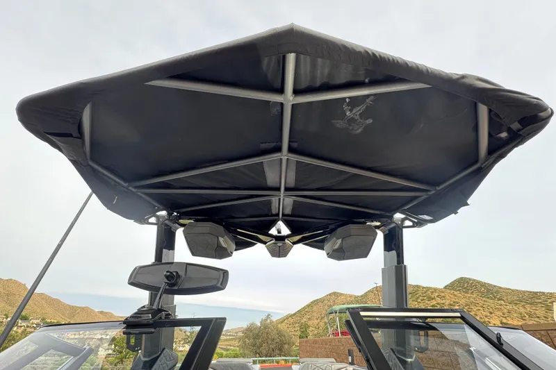 Slide: The Image of 2022 Nautique Super Air Nautique G25 Paragon boat canopy and speakers, outdoor setting. - 18