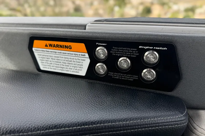 Slide: The Image of Control panel of 2022 Nautique Super Air Nautique G25 Paragon with warning label. - 25