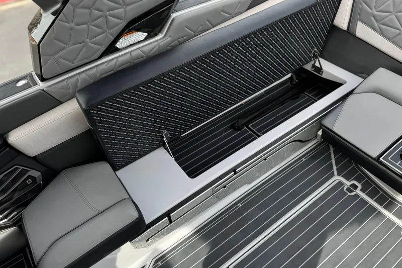 Slide: The Image of 2022 Nautique Super Air Nautique G25 Paragon interior seating and storage detail. - 34