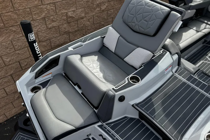 Slide: The Image of 2022 Nautique Super Air Nautique G25 Paragon boat seating with luxurious gray upholstery. - 40