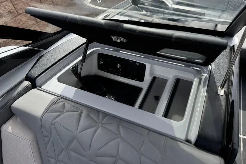Slide: The Image of 2022 Nautique Super Air Nautique G25 Paragon storage compartment with sleek design and controls. - 46