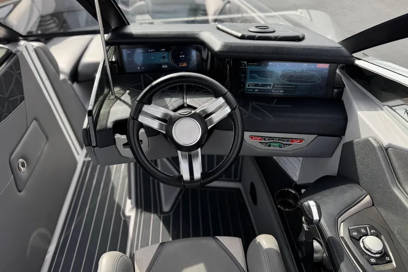 Slide: The Image of 2022 Nautique Super Air Nautique G25 Paragon cockpit with modern steering and digital displays. - 49