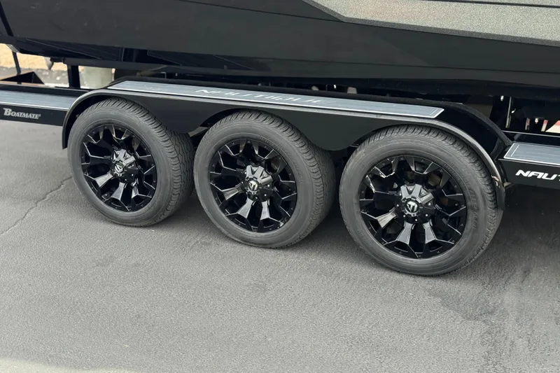 Slide: The Image of Triple-axle trailer with black wheels for 2022 Nautique Super Air Nautique G25 Paragon. - 58