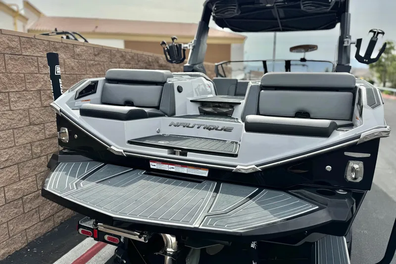 Slide: The Image of 2022 Nautique Super Air Nautique G25 Paragon boat, rear view, showcasing sleek design and seating. - 8
