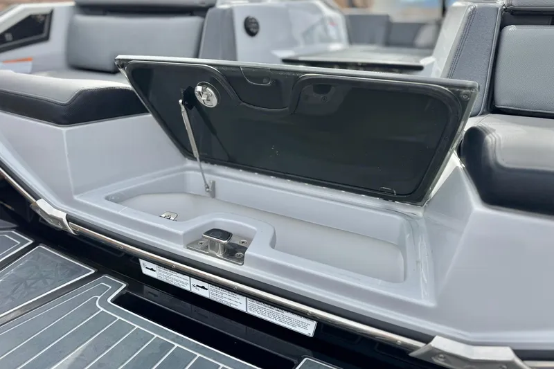 Slide: The Image of 2022 Nautique Super Air Nautique G25 Paragon storage compartment open, showcasing interior details. - 9