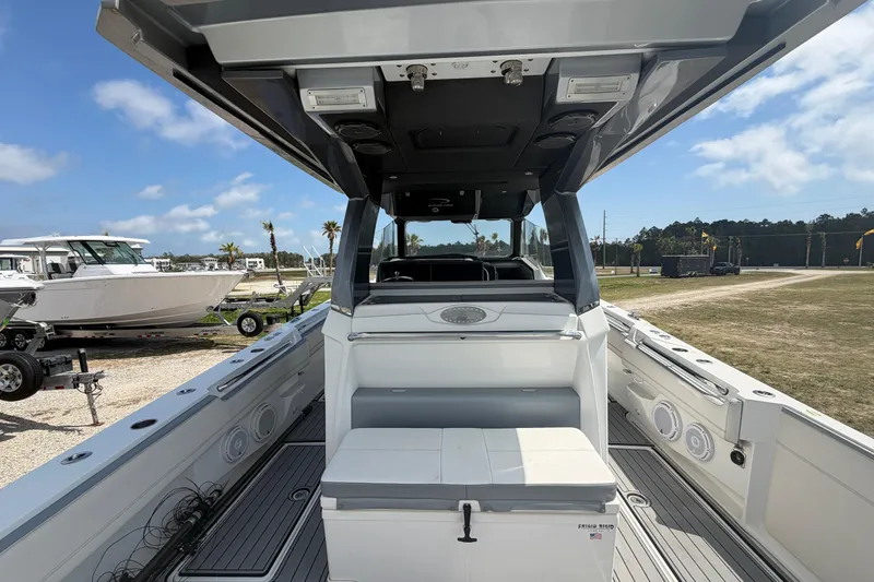 Slide: The Image of 2018 Nor-Tech 452 Super Fish boat interior with seating and storage, parked outdoors. - 13