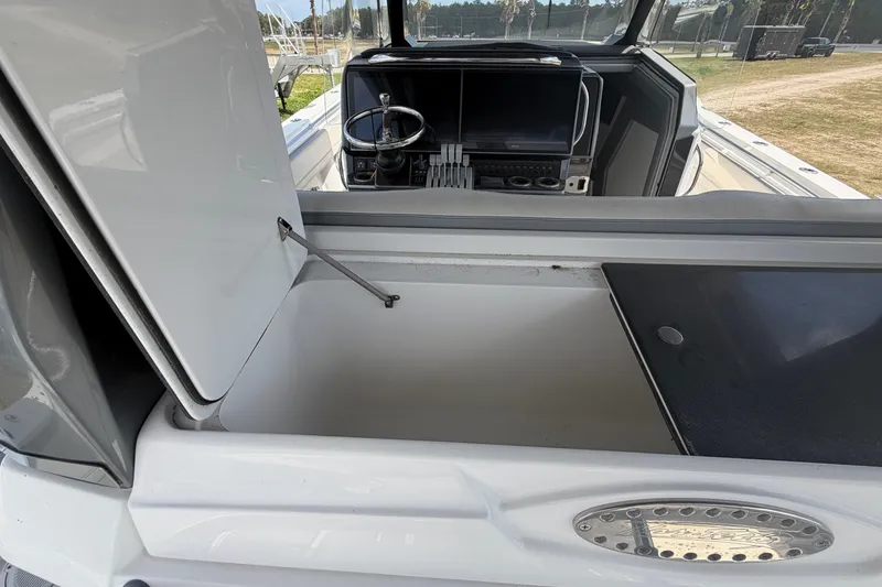 Slide: The Image of 2018 Nor-Tech 452 Super Fish boat interior with open storage compartment and cockpit view. - 14