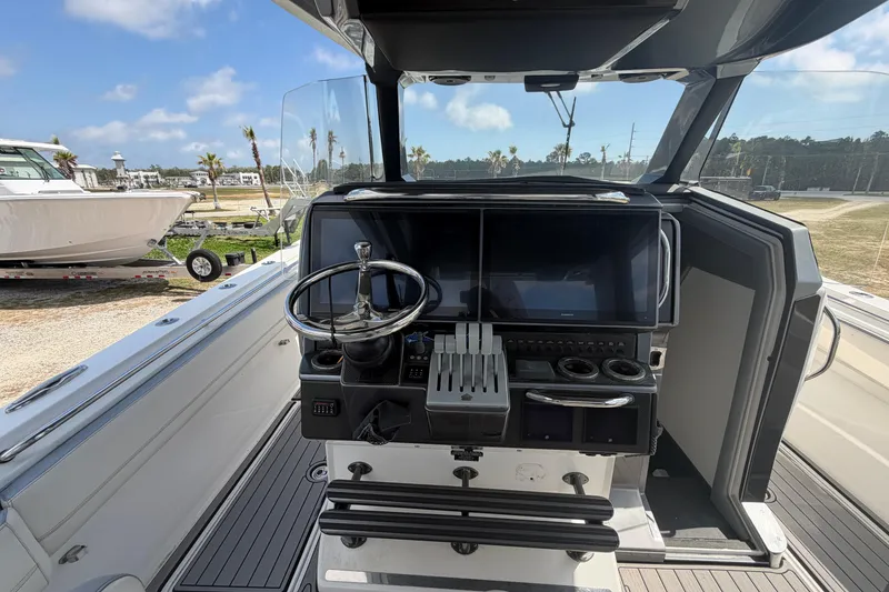 Slide: The Image of 2018 Nor-Tech 452 Super Fish boat cockpit with steering wheel and control panel. - 15