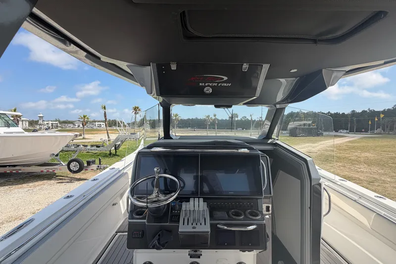 Slide: The Image of 2018 Nor-Tech 452 Super Fish boat cockpit with steering wheel and control panel. - 16