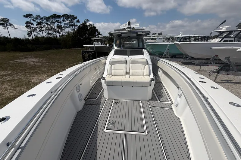 Slide: The Image of 2018 Nor-Tech 452 Super Fish boat with spacious deck and seating, docked outdoors. - 24